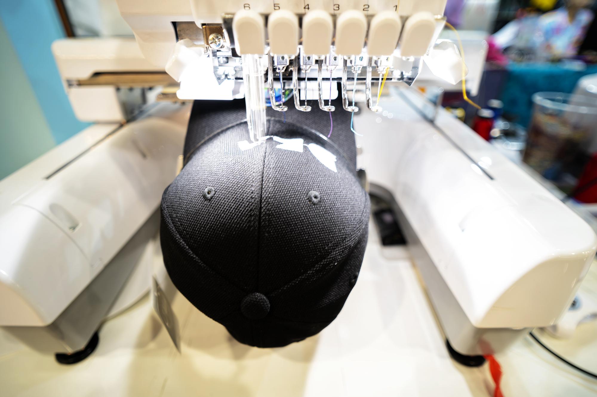 Rows of embroidered caps on a rack